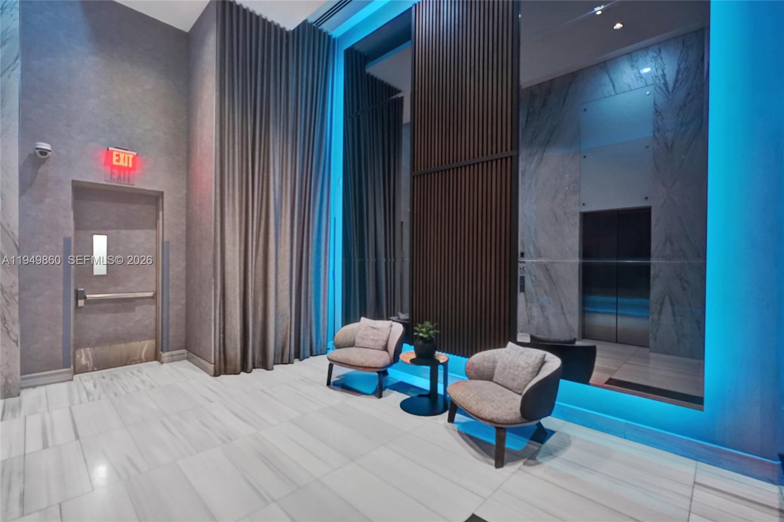 1100 Biscayne Boulevard, Unit 3708 Miami, FL 33132 - Photo 41 of 43 a bedroom with a bed and a chair