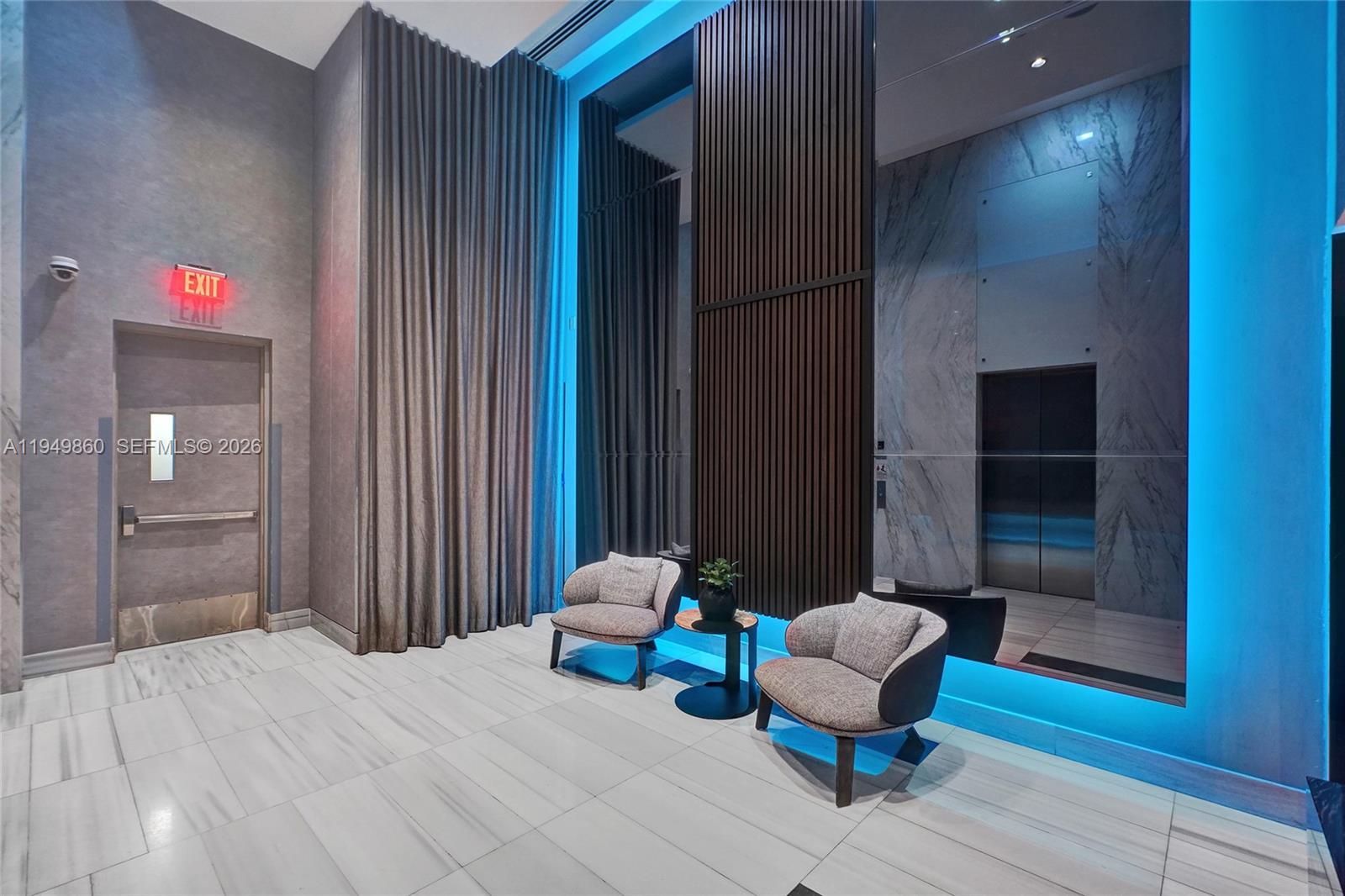 1100 Biscayne Boulevard, Unit 3708 Miami, FL 33132 - Photo 42 of 43 a spacious bedroom with a bed and a chair