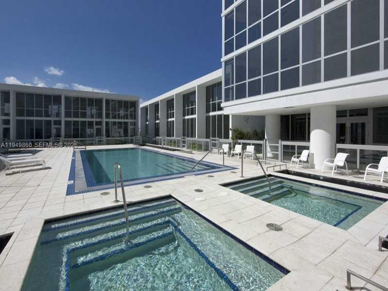 1100 Biscayne Boulevard, Unit 3708 Miami, FL 33132 - Photo 43 of 43 a view of a house with pool and chairs