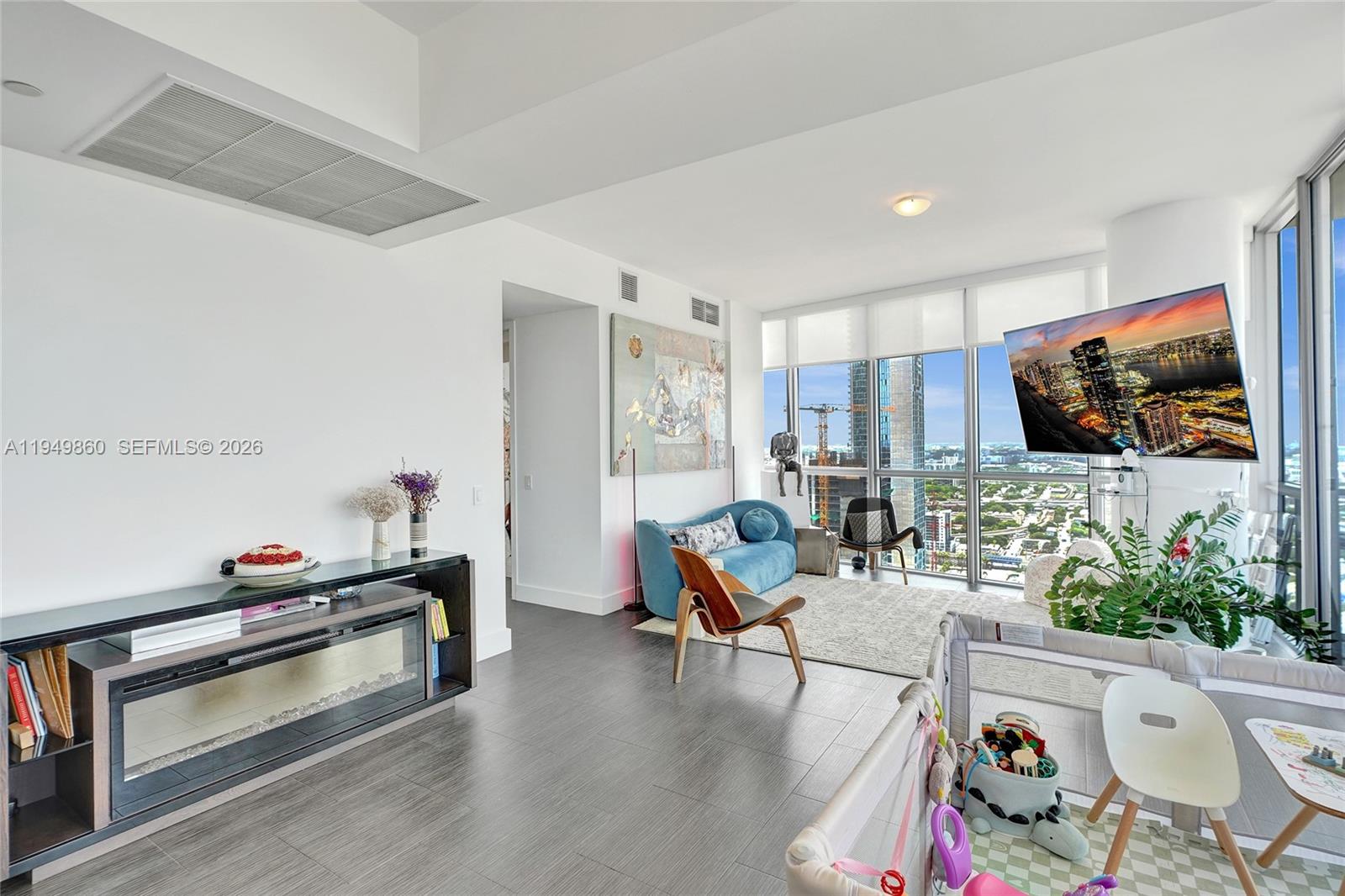 1100 Biscayne Boulevard, Unit 3708 Miami, FL 33132 - Photo 10 of 43 a living room with furniture and a flat screen tv