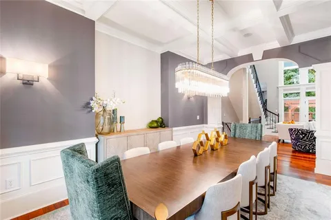 a living room with furniture a fireplace and a large window