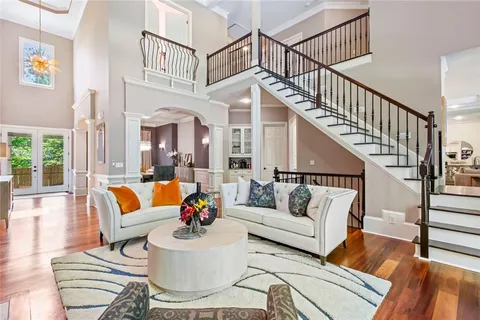 a living room with furniture fireplace and a large window