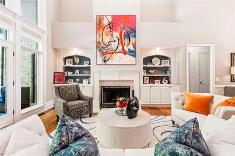 a living room with furniture and a floor to ceiling window