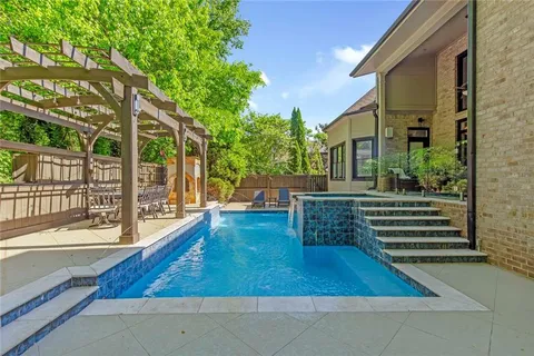 a view of a dining room with furniture wooden floor and chandelier