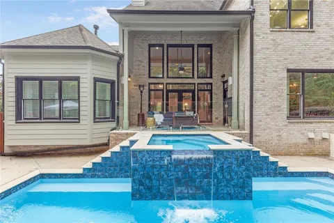 a kitchen with stainless steel appliances a table chairs and chandelier