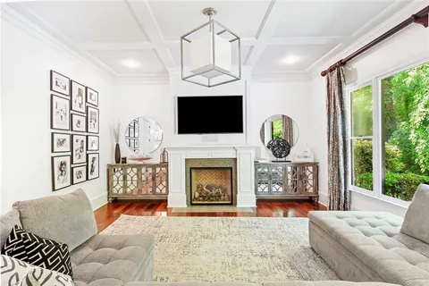 a living room with furniture and flowers