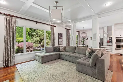 a living room with furniture and a baby crib