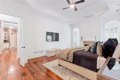 a bedroom with a large bed and a chandelier