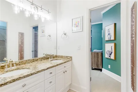 a view of backyard with a table and chairs and potted plants