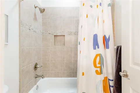 an aerial view of a house with a yard and trees