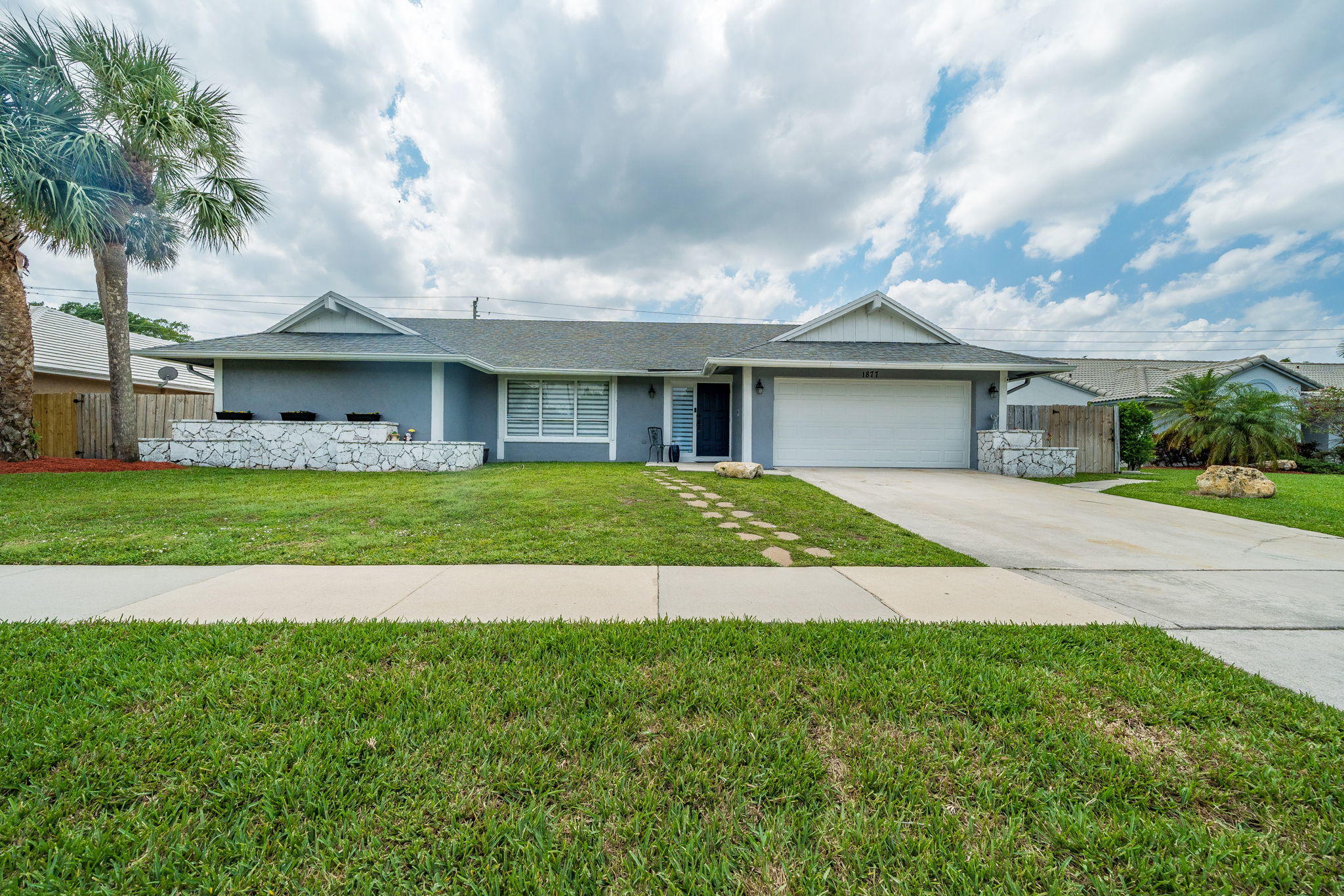 1877 Shower Tree Way Wellington, FL 33414 - Photo 1 of 47 a house with swimming pool in front of it