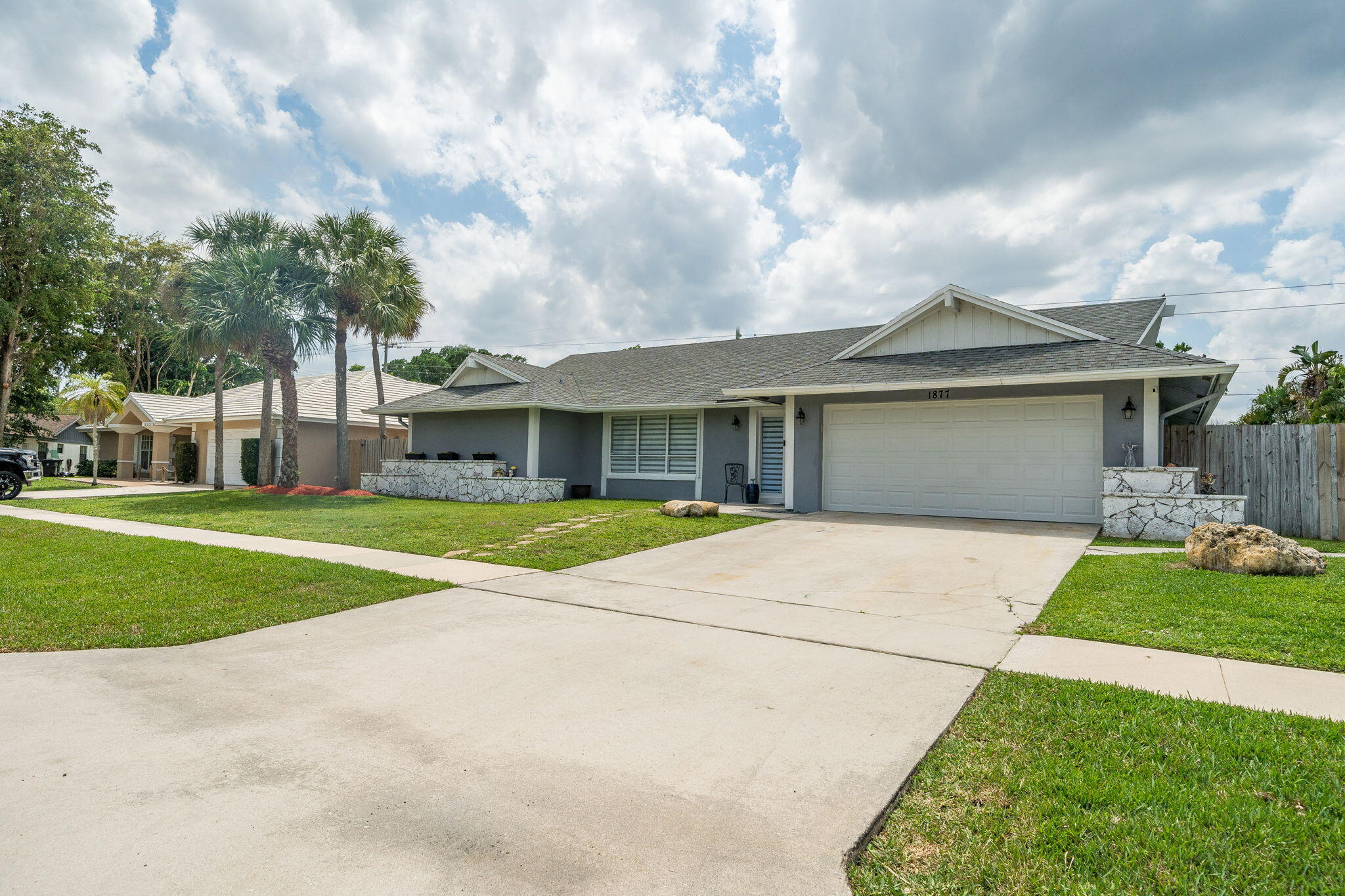 1877 Shower Tree Way Wellington, FL 33414 - Photo 2 of 47 a view of house with outdoor space and street view