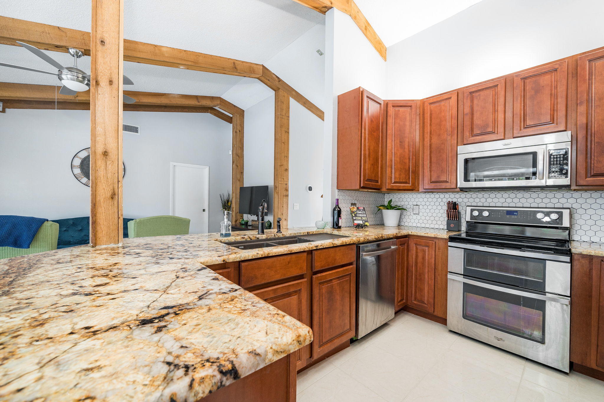 1877 Shower Tree Way Wellington, FL 33414 - Photo 16 of 47 a kitchen with stainless steel appliances a stove a sink and a microwave