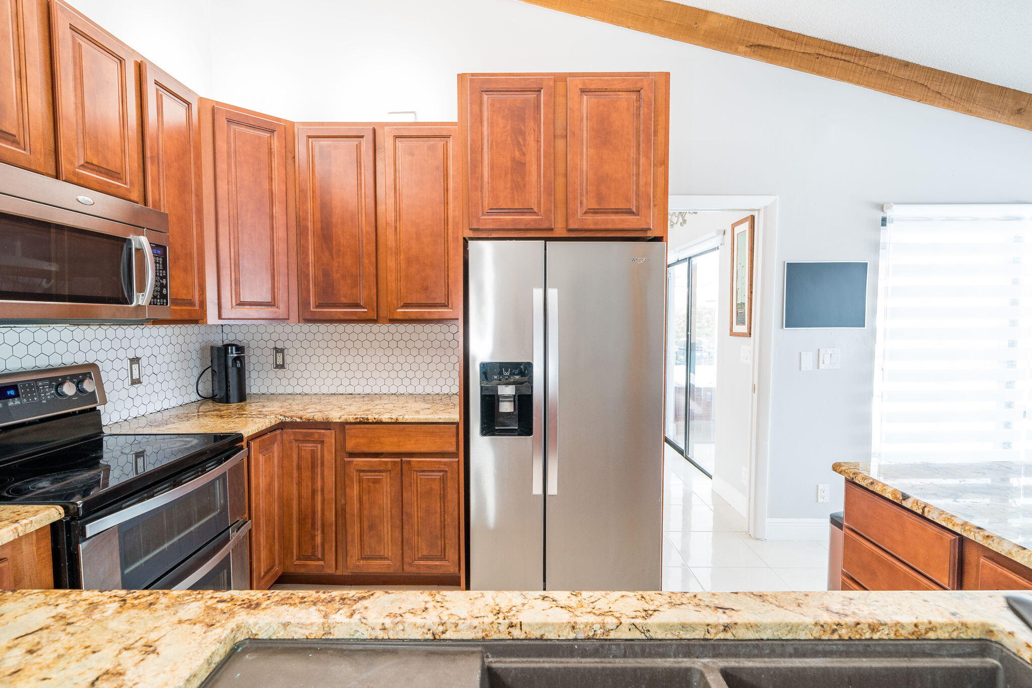 1877 Shower Tree Way Wellington, FL 33414 - Photo 18 of 47 a kitchen with stainless steel appliances granite countertop a refrigerator stove and oven