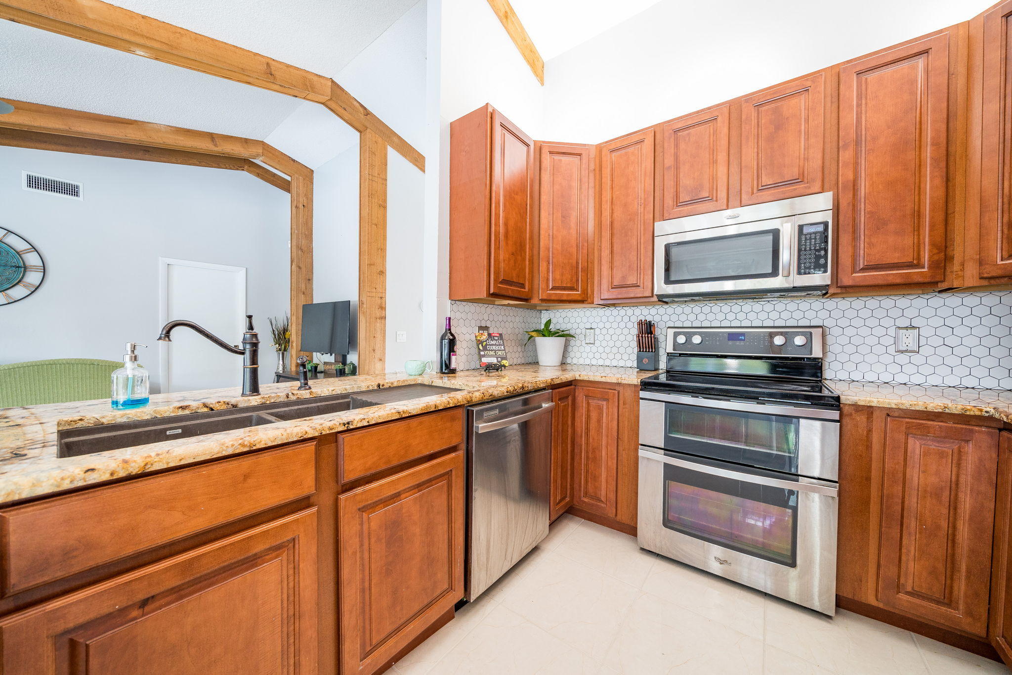 1877 Shower Tree Way Wellington, FL 33414 - Photo 19 of 47 a kitchen with stainless steel appliances granite countertop a stove a sink and a microwave