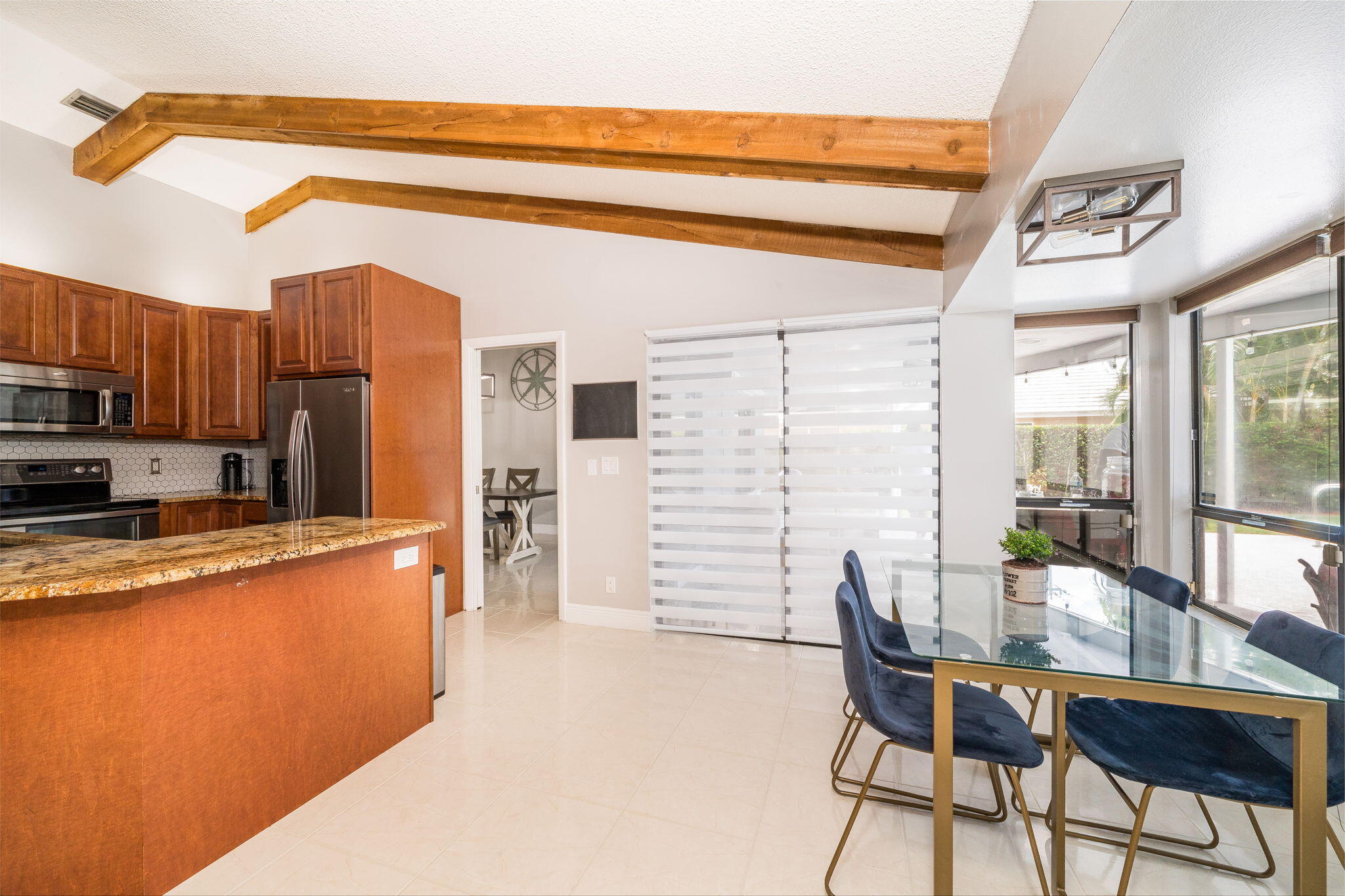1877 Shower Tree Way Wellington, FL 33414 - Photo 23 of 47 a living room with stainless steel appliances kitchen island granite countertop furniture and a kitchen view