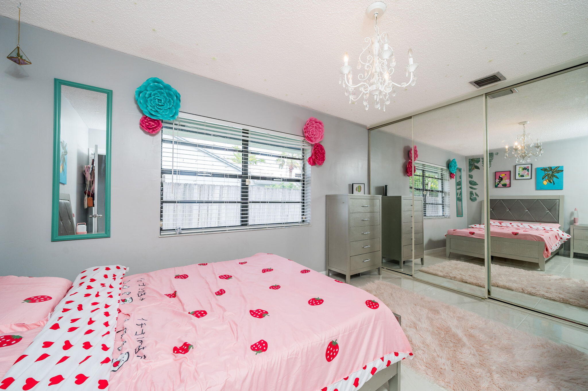 1877 Shower Tree Way Wellington, FL 33414 - Photo 28 of 47 a bedroom next to a bed and a chandelier