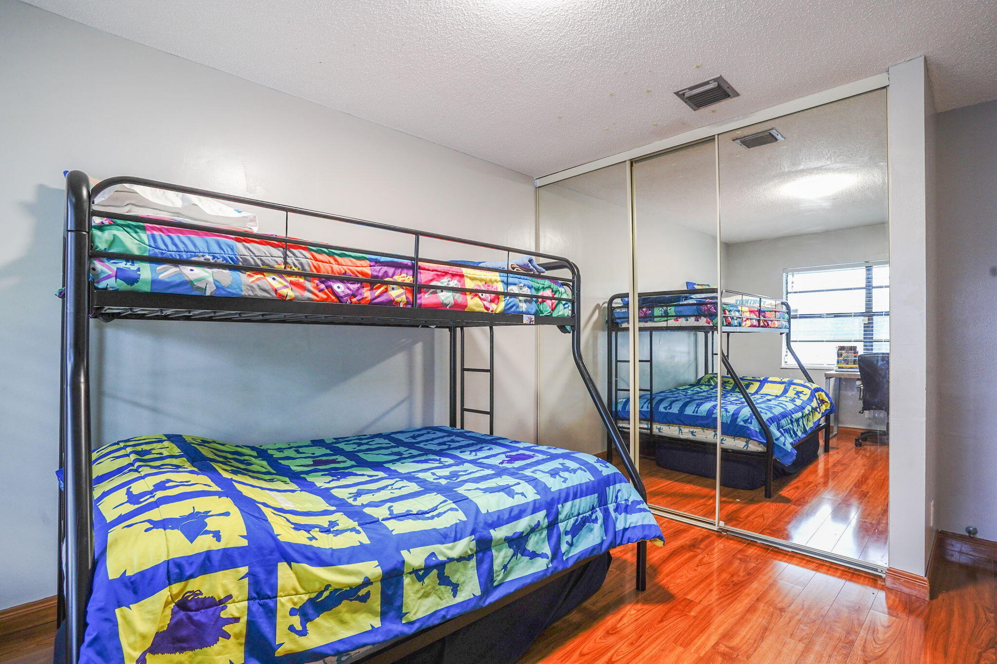 1877 Shower Tree Way Wellington, FL 33414 - Photo 30 of 47 a bedroom with a bed and a chandelier