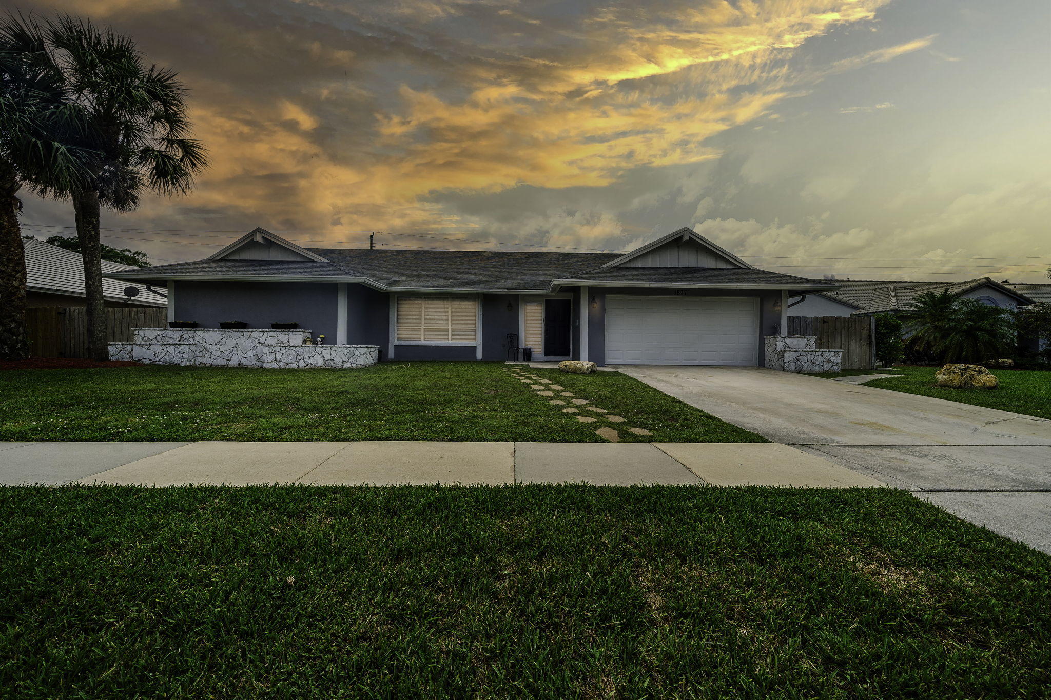 1877 Shower Tree Way Wellington, FL 33414 - Photo 4 of 47 a front view of a house with garden