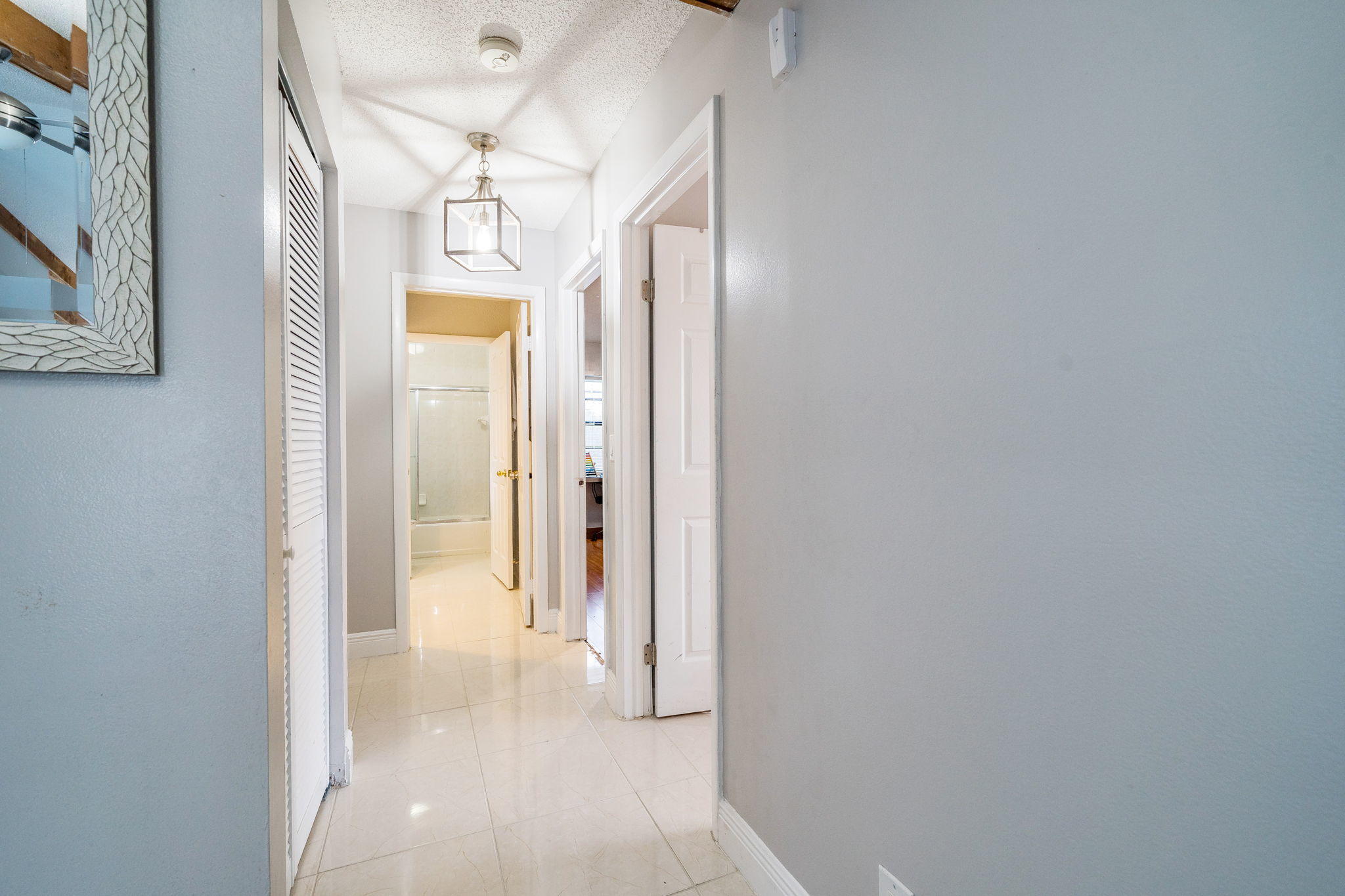 1877 Shower Tree Way Wellington, FL 33414 - Photo 35 of 47 a view of a hallway with a chandelier