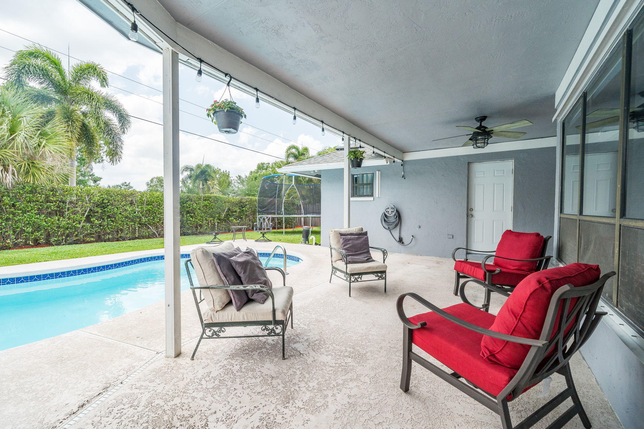 1877 Shower Tree Way Wellington, FL 33414 - Photo 42 of 47 a living room with furniture and floor to ceiling windows