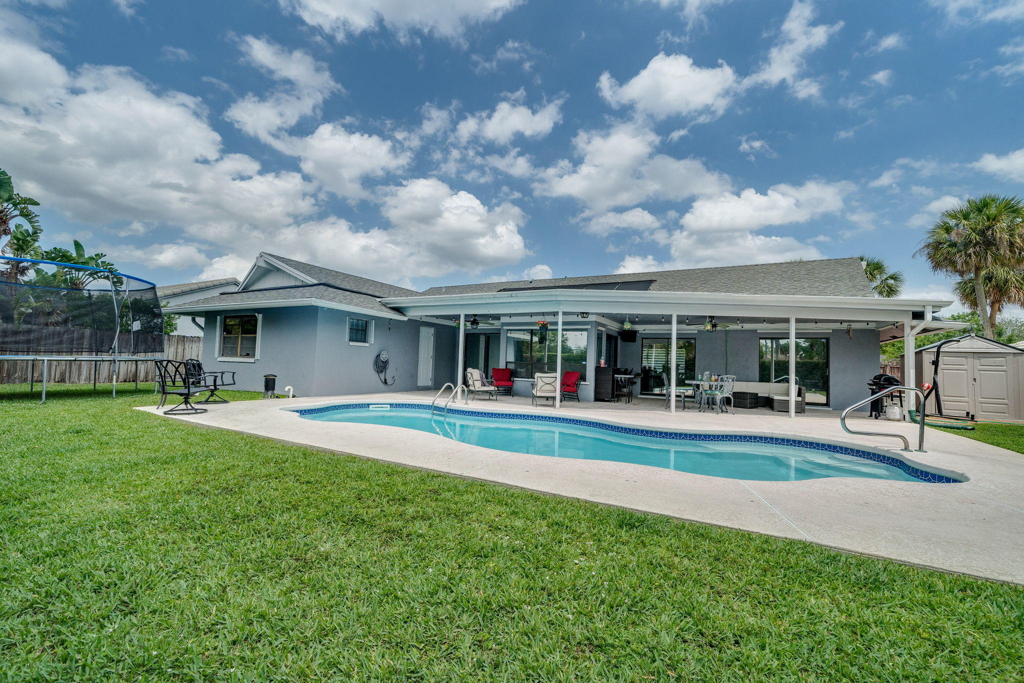 1877 Shower Tree Way Wellington, FL 33414 - Photo 43 of 47 a view of house in front of a big yard with large trees