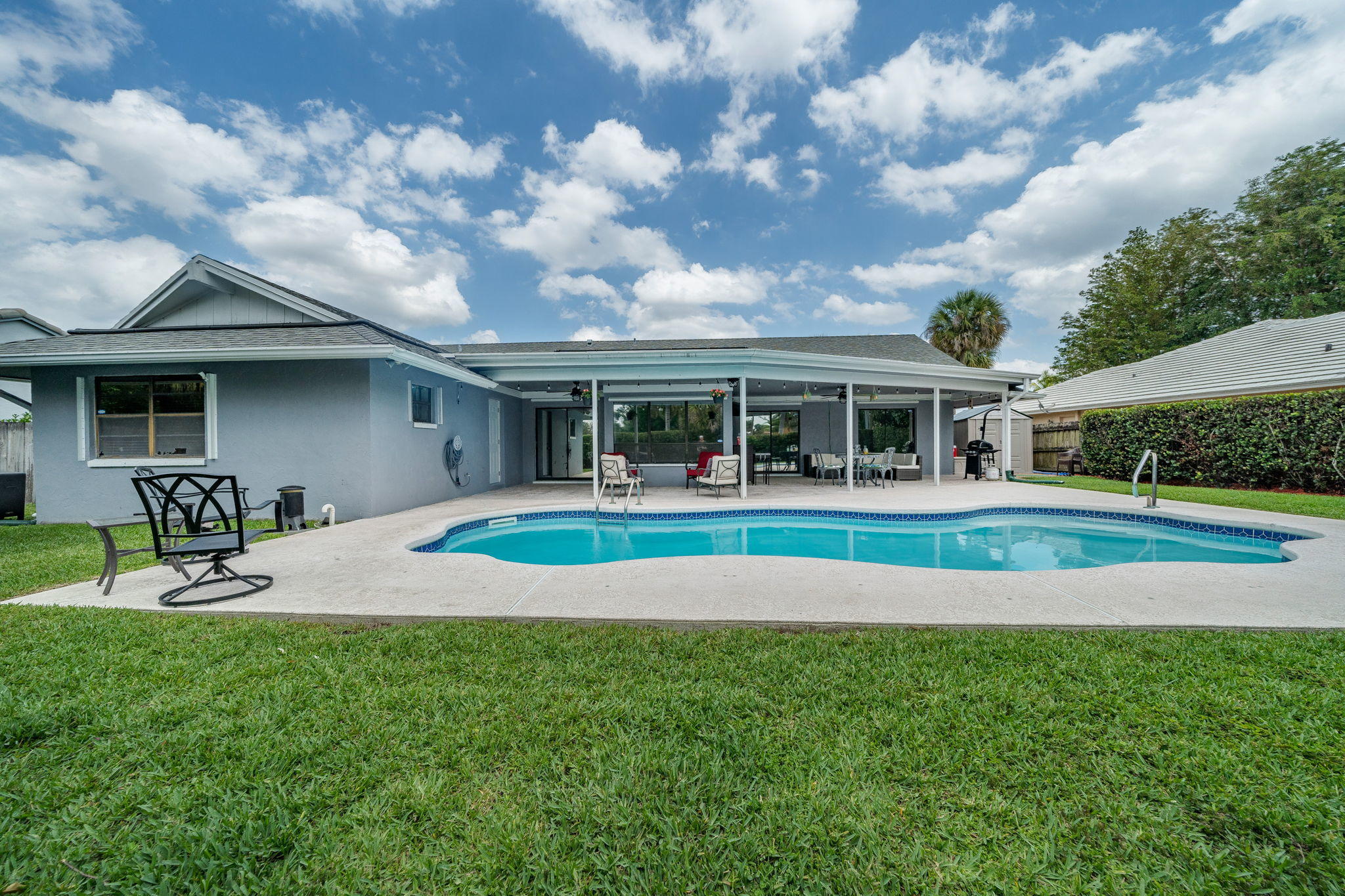 1877 Shower Tree Way Wellington, FL 33414 - Photo 44 of 47 a view of house with a big yard and large trees