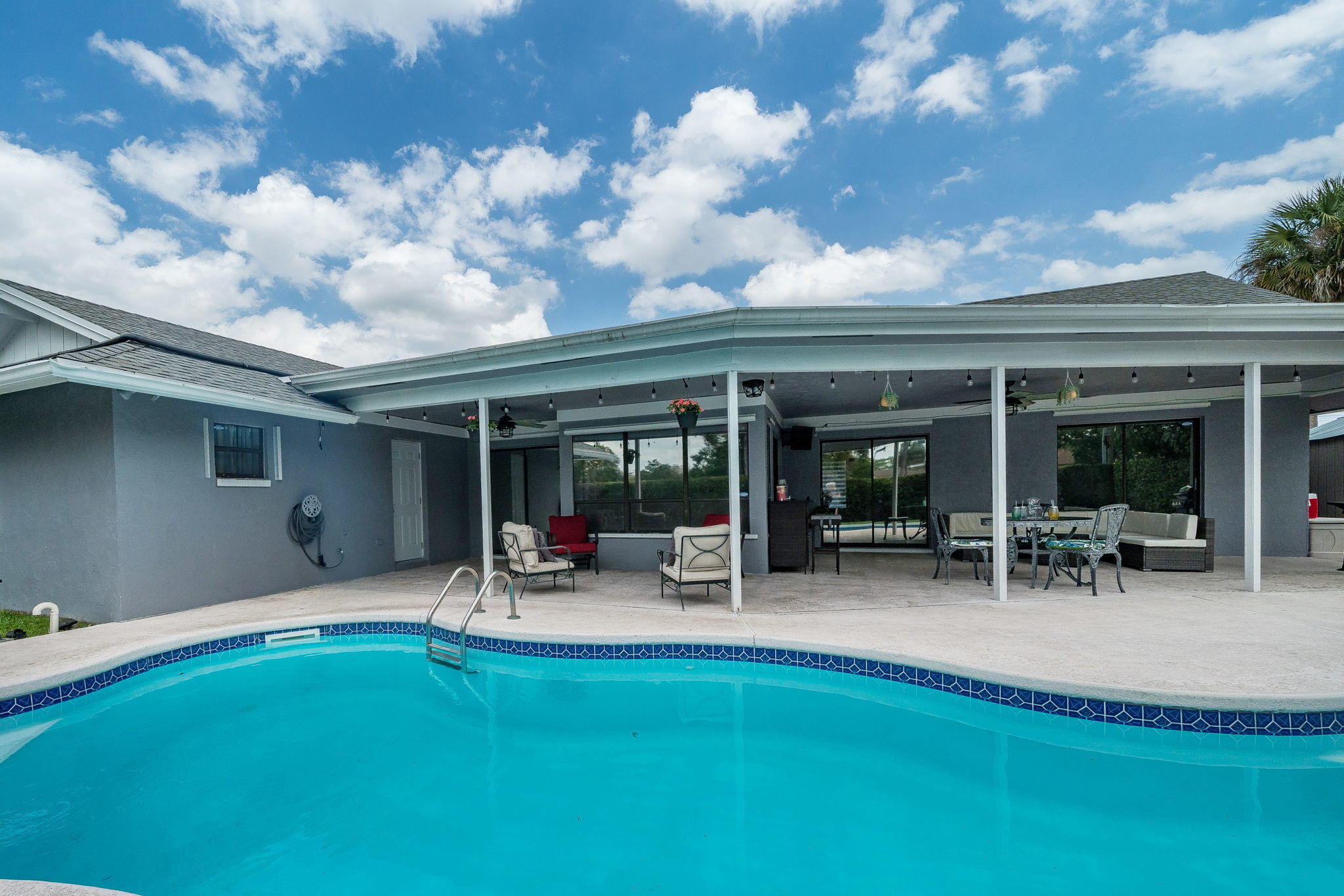 1877 Shower Tree Way Wellington, FL 33414 - Photo 45 of 47 a backyard of a house with table and chairs