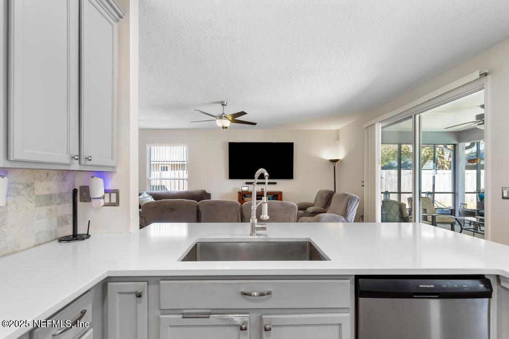13694 Fish Eagle Drive West Jacksonville, FL 32226 - Photo 13 of 62 a kitchen with a sink a counter and cabinets