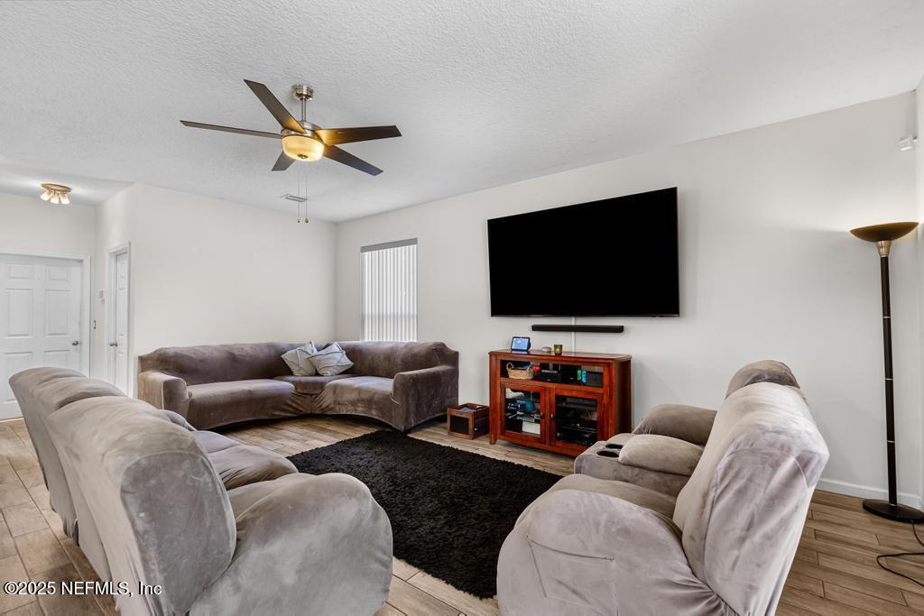 13694 Fish Eagle Drive West Jacksonville, FL 32226 - Photo 17 of 62 a living room with furniture and a flat screen tv