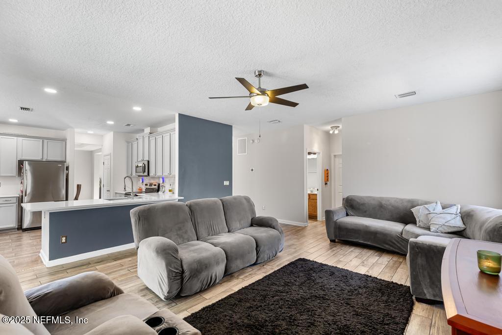 13694 Fish Eagle Drive West Jacksonville, FL 32226 - Photo 18 of 62 a living room with furniture and a rug