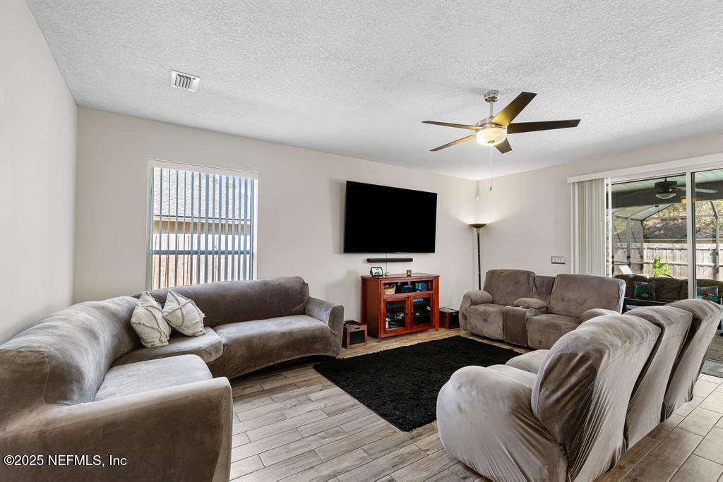 13694 Fish Eagle Drive West Jacksonville, FL 32226 - Photo 19 of 62 a living room with furniture and a flat screen tv