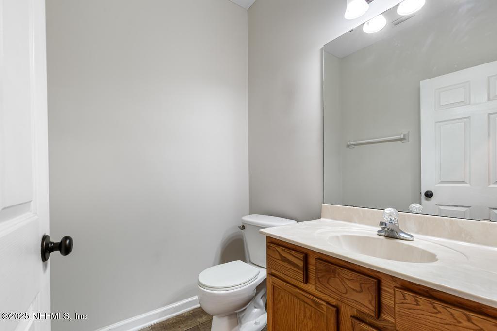 13694 Fish Eagle Drive West Jacksonville, FL 32226 - Photo 20 of 62 a bathroom with a granite countertop sink a toilet and a mirror