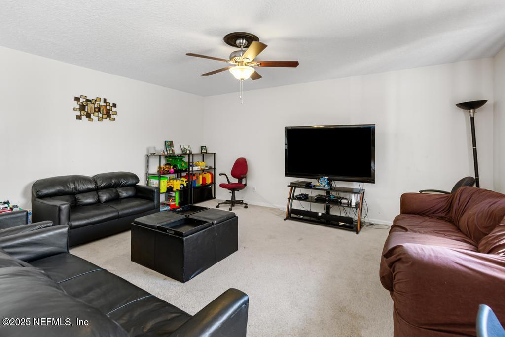 13694 Fish Eagle Drive West Jacksonville, FL 32226 - Photo 26 of 62 a living room with furniture and a flat screen tv