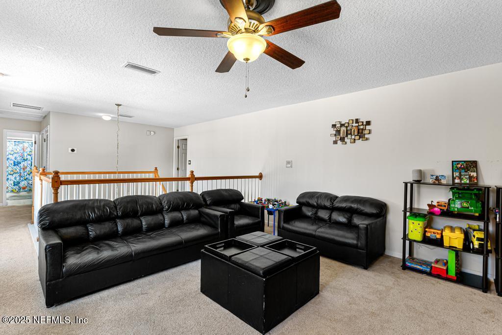 13694 Fish Eagle Drive West Jacksonville, FL 32226 - Photo 27 of 62 a living room with furniture and a couch