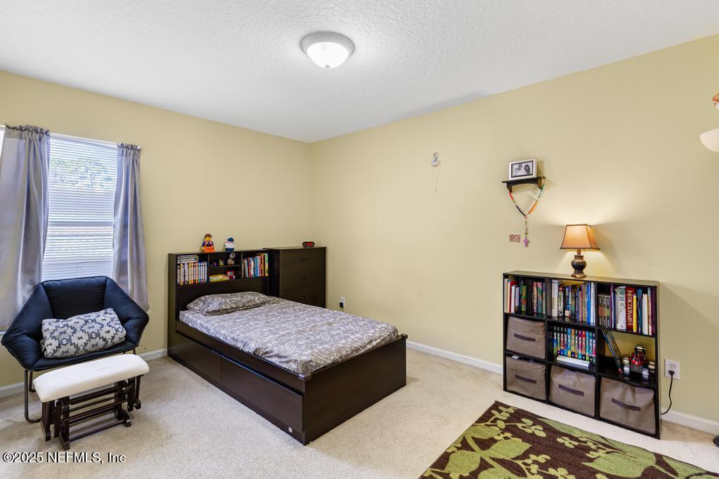 13694 Fish Eagle Drive West Jacksonville, FL 32226 - Photo 28 of 62 a bedroom with a bed and furniture