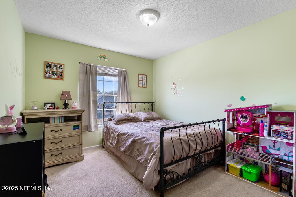 13694 Fish Eagle Drive West Jacksonville, FL 32226 - Photo 29 of 62 a bedroom with a bed and dresser