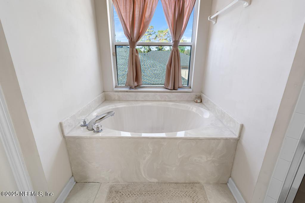 13694 Fish Eagle Drive West Jacksonville, FL 32226 - Photo 37 of 62 a white bath tub sitting in a bathroom