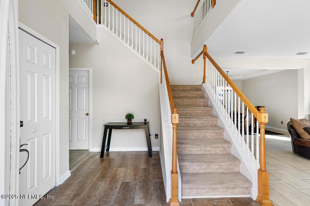 13694 Fish Eagle Drive West Jacksonville, FL 32226 - Photo 4 of 62 a view of staircase with wooden floor and a rug