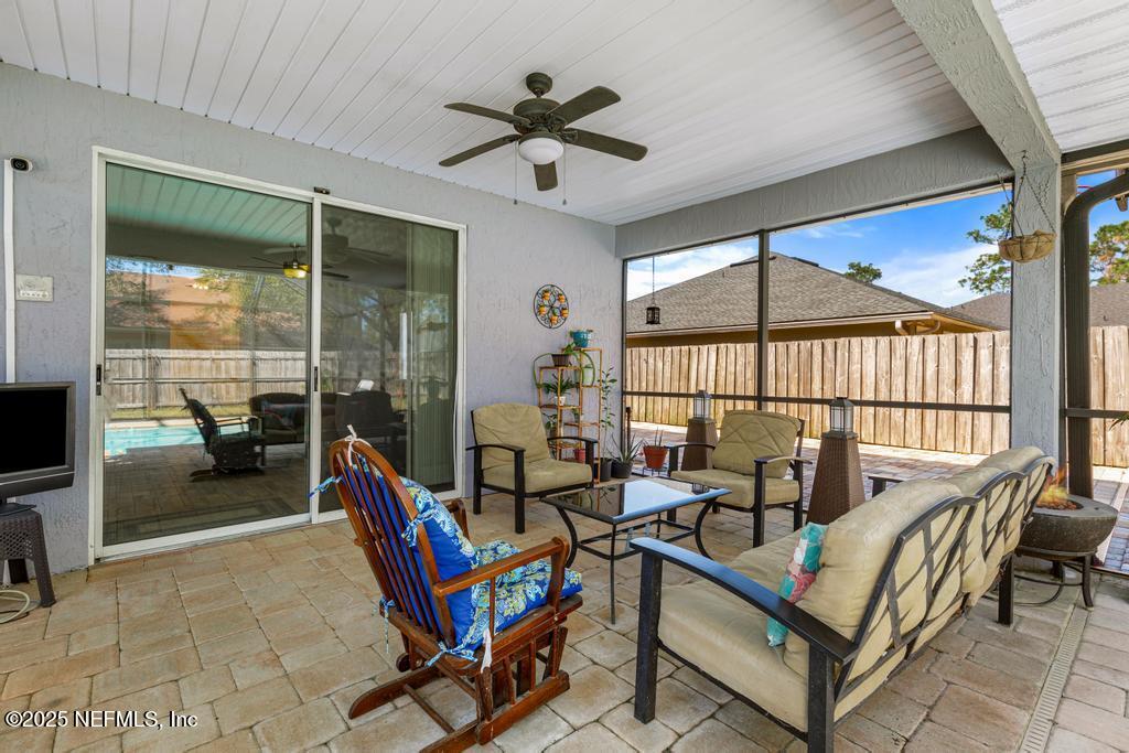 13694 Fish Eagle Drive West Jacksonville, FL 32226 - Photo 41 of 62 a living room with furniture a flat screen tv and a floor to ceiling window