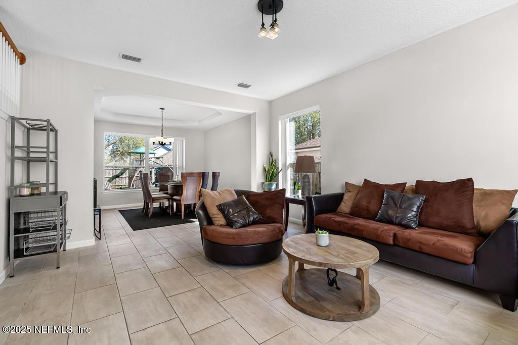 13694 Fish Eagle Drive West Jacksonville, FL 32226 - Photo 6 of 62 a living room with furniture and a potted plant