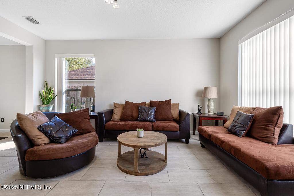 13694 Fish Eagle Drive West Jacksonville, FL 32226 - Photo 7 of 62 a living room with furniture and a large window
