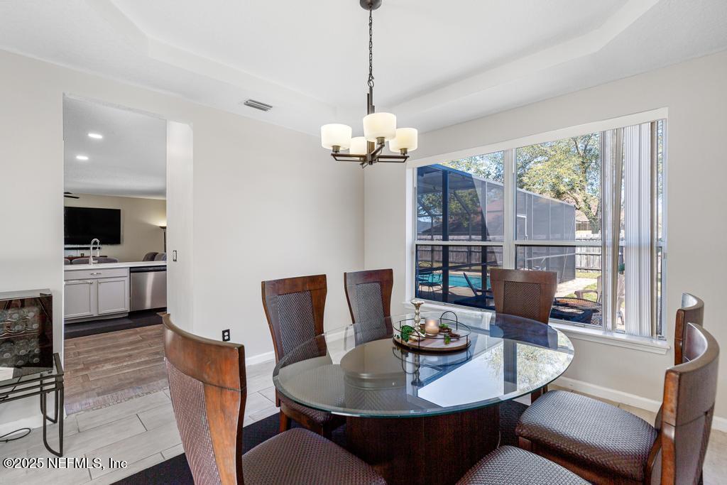 13694 Fish Eagle Drive West Jacksonville, FL 32226 - Photo 10 of 62 a view of a dining room with furniture window and wooden floor