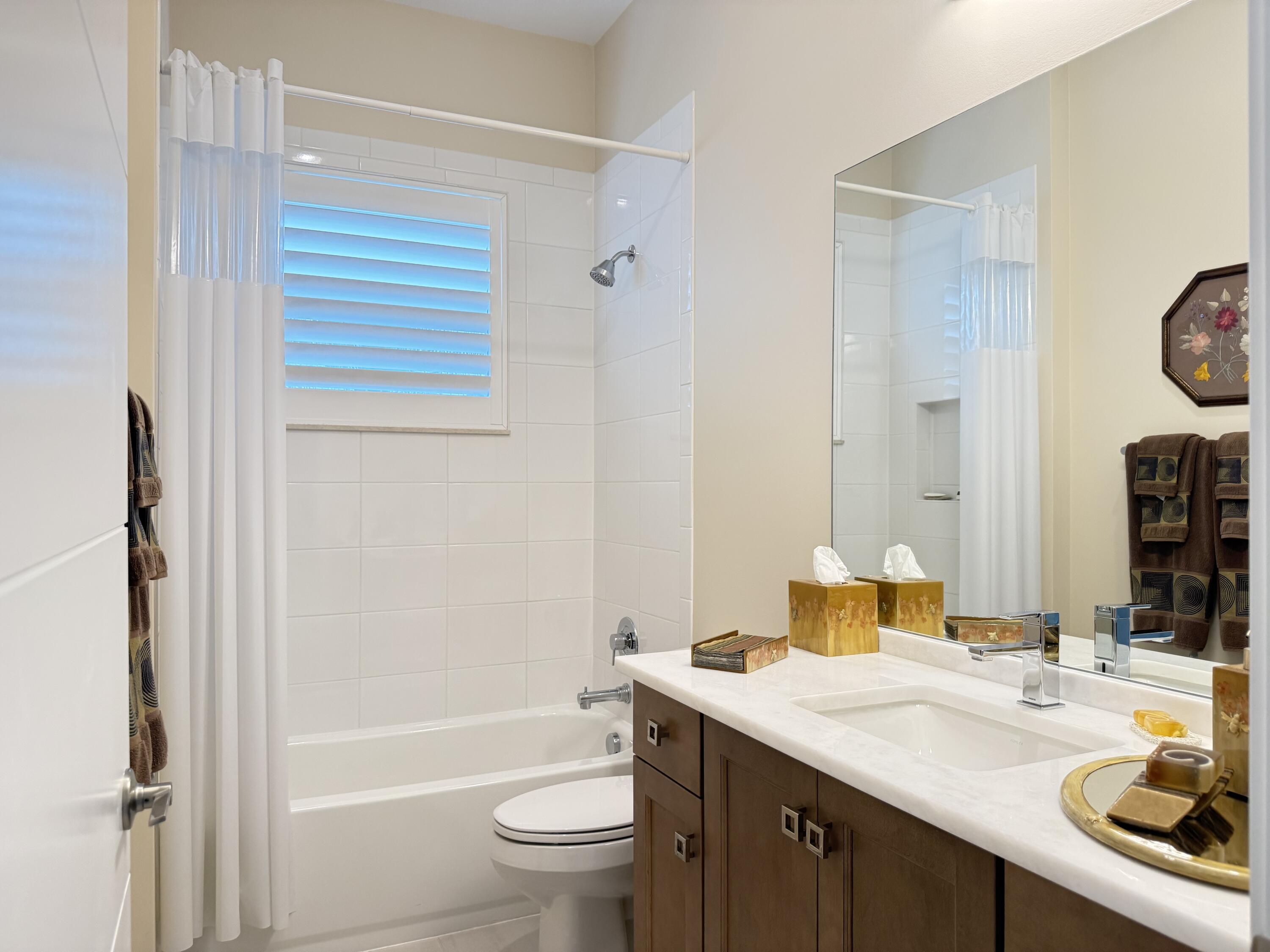 8575 Dearborn River Way Boca Raton, FL 33496 - Photo 18 of 32 a bathroom with a sink a toilet and shower