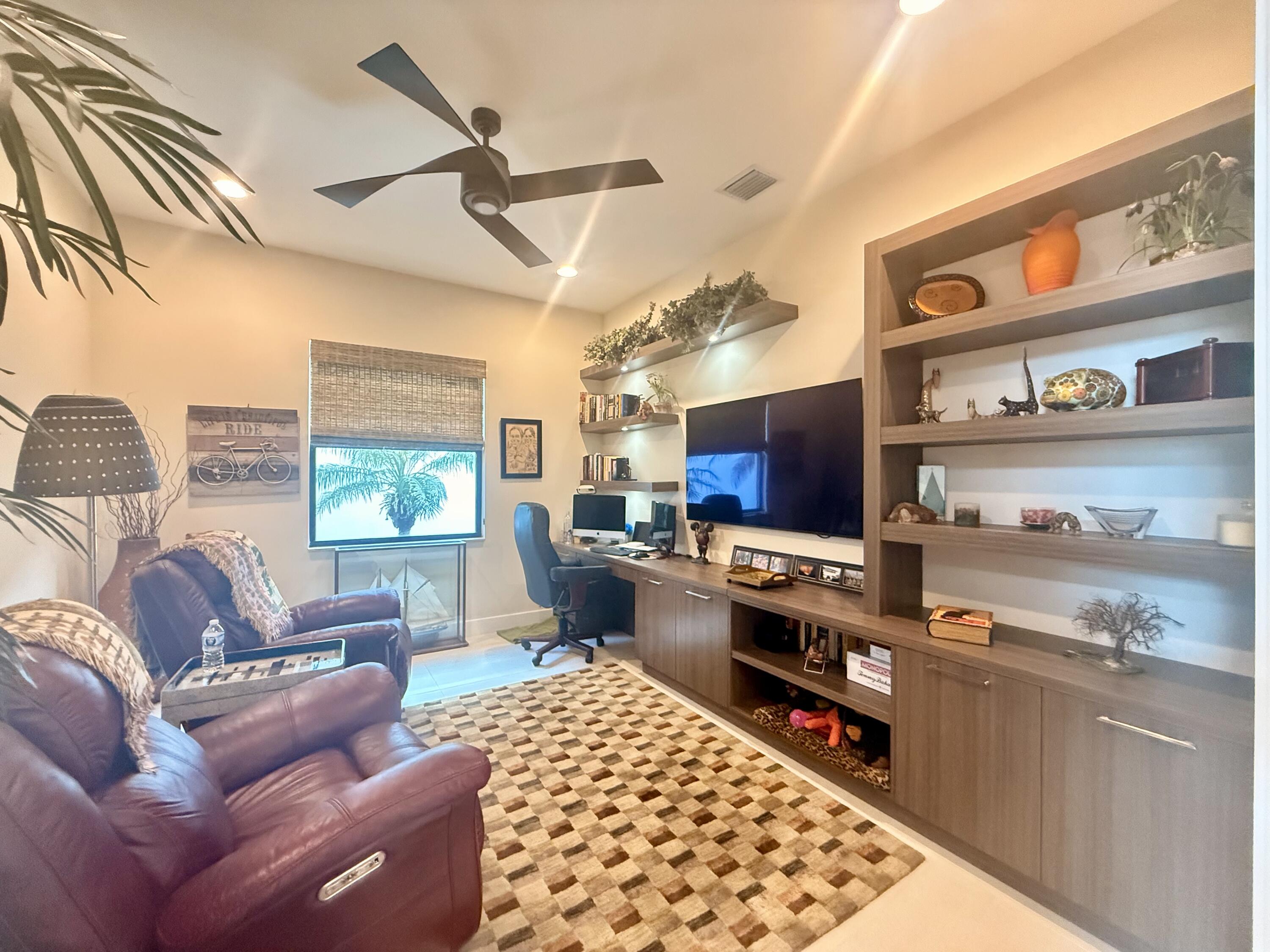 8575 Dearborn River Way Boca Raton, FL 33496 - Photo 31 of 32 a living room with furniture and a flat screen tv
