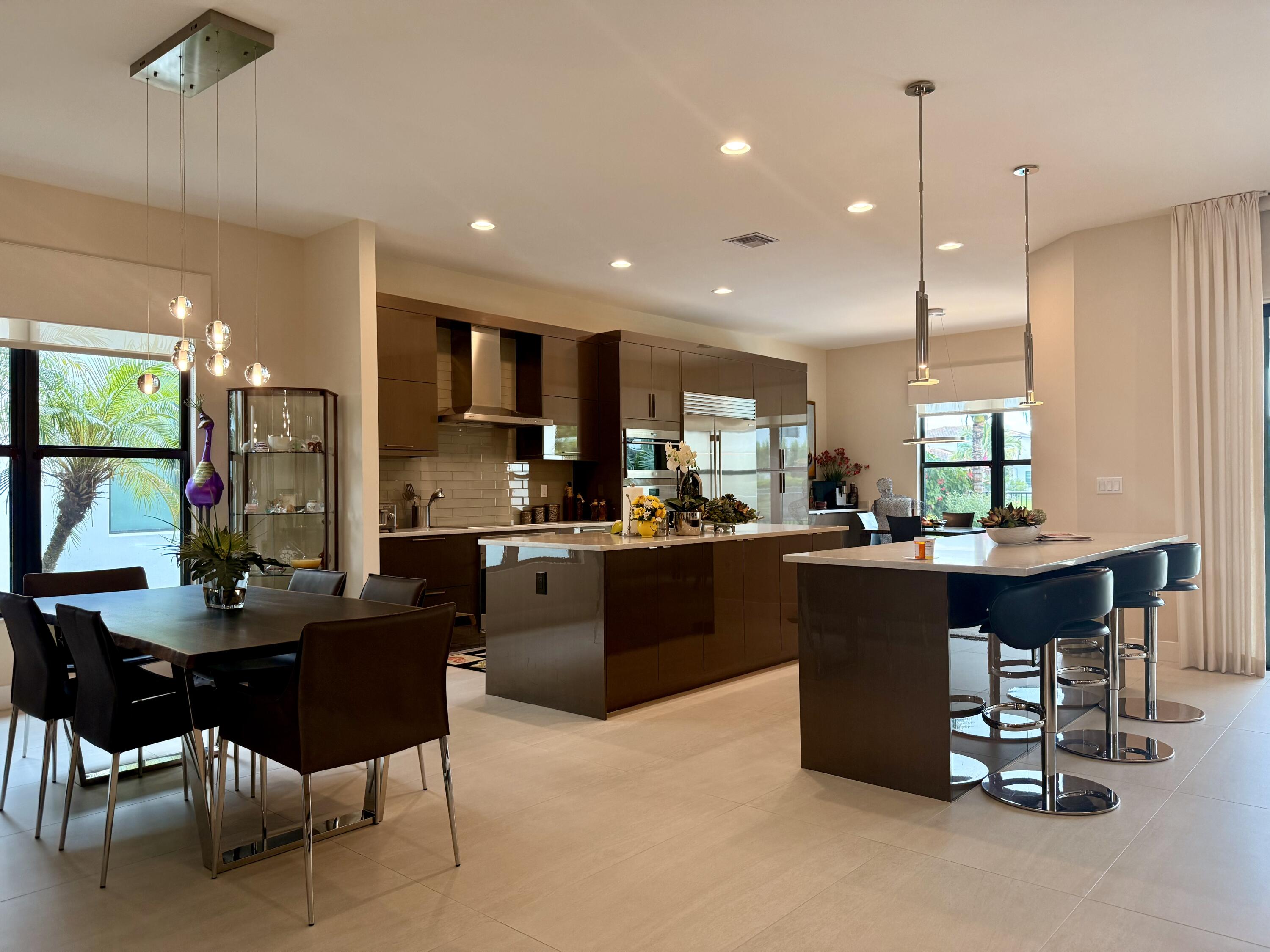 8575 Dearborn River Way Boca Raton, FL 33496 - Photo 10 of 32 a kitchen with kitchen island granite countertop a sink and a refrigerator