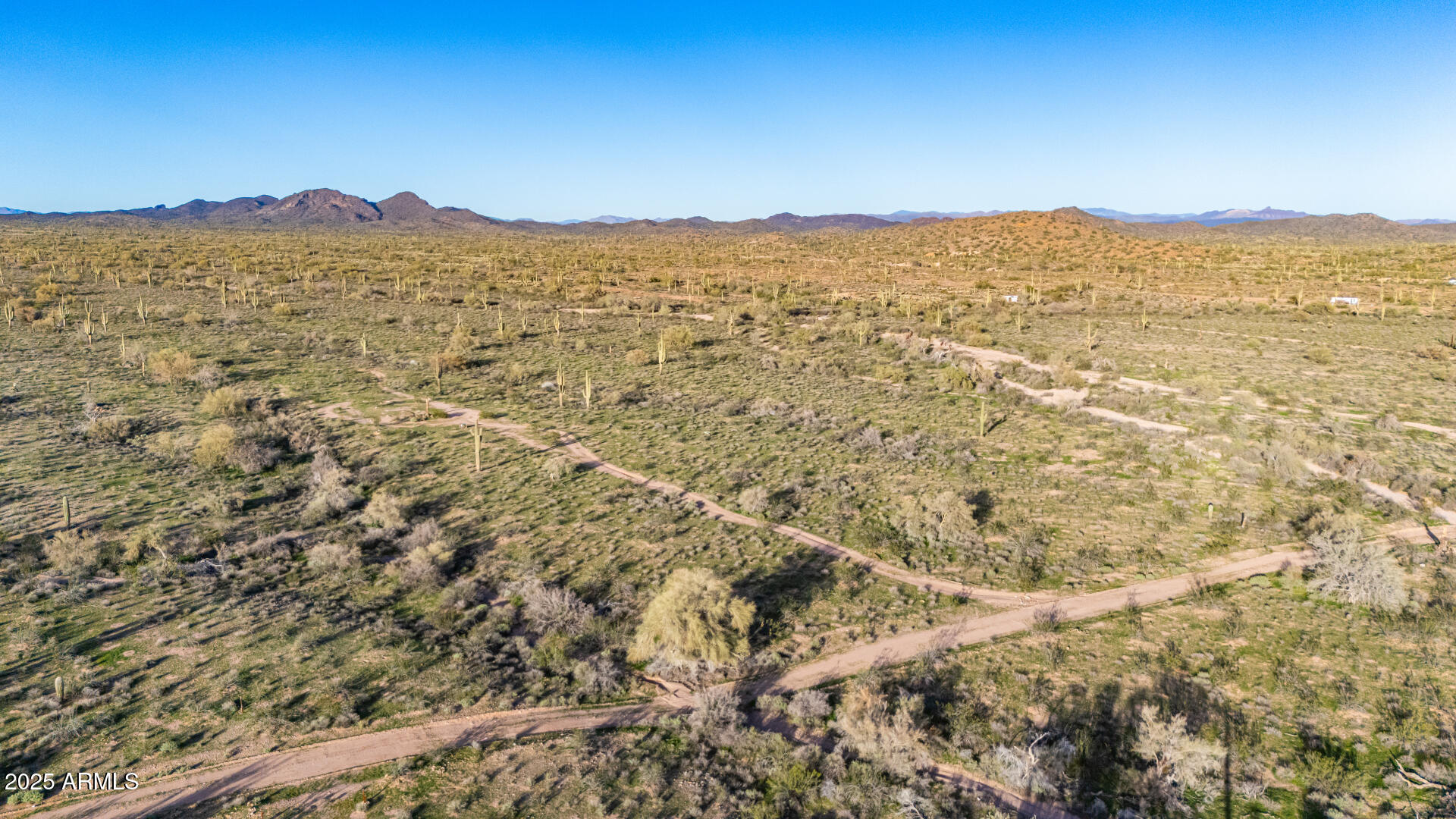 31200 West Tamar Road, Unit 27 Wittmann, AZ 85361 - Photo 5 of 14 a view of a mountain range in a cloudy sky