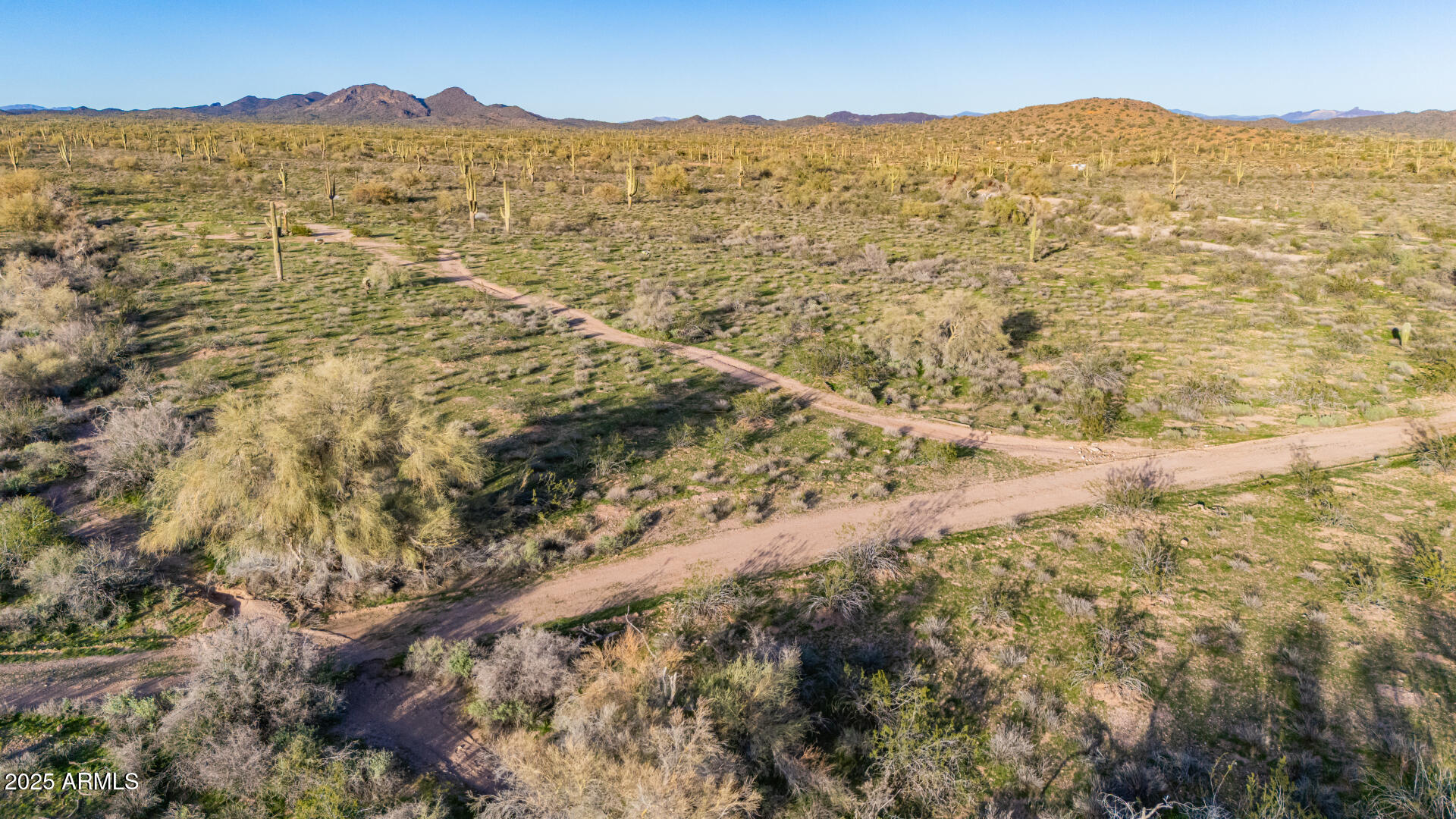 31200 West Tamar Road, Unit 27 Wittmann, AZ 85361 - Photo 6 of 14 a view of a mountain range in a cloudy sky