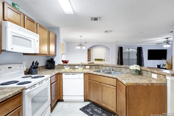 a kitchen with a refrigerator sink and stove