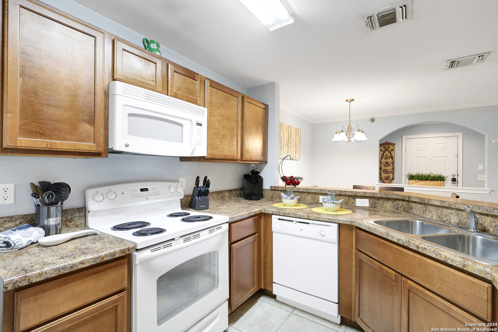 7323 Snowden Road, Unit 3308 San Antonio, TX 78229 - Photo 12 of 26 a kitchen with a sink stove top oven and cabinets